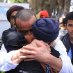 People embrace and shed tears during a prisoner release operation in Yemen, facilitated by the ICRC as a neutral intermediary.