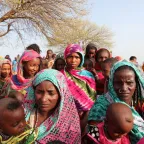 A group of African women and children facing the camera.