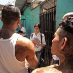An ICRC employee speaking with detainees at the San Salvador, Cojutepeque Penal Centre.