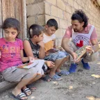 The ICRC distributes flyers to children to inform them on the danger of landmines in Tovuz, Azerbaijan.