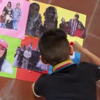 Un niño pega fotografías de sus seres queridos desaparecidos en hojas de colores. 