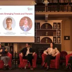 Four people sat on a stage holding a discussion