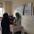 An Afghan Red Crescent Soceity healthcare worker providing assistance to a patient