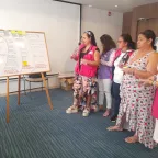 Women in a room looking at a whiteboard