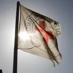 ICRC flag with sun behind
