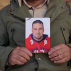 A brother of Family of missing holding his picture