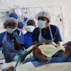 Surgeons treating a patient
