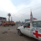 ICRC landcruiser next to electricity pylons in Goma