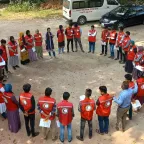 ICRC staff standing facing each other in a circle with picture taken from above
