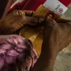 A woman's hands holding a picture of a missing loved one. ICRC