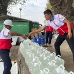 ICRC workers providing clean water containers in Myanmar