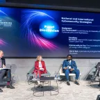 four people sitting on a panel