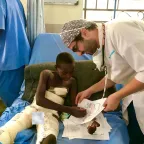 Egyptian anesthesiologist Dr. Aktham Al-Farnawani encourages a child to color after he was injured in an explosion in Maiduguri, Nigeria.