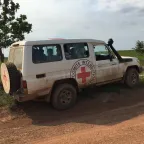 ICRC vehicle with emblem on the side and back parked on a road