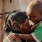 Somalia. Nadifa, her son and the rest of her family have been displaced because of armed conflict, and now live in makeshift shelters. The ICRC works with the Somali Red Crescent Society to provide them and other displaced people with support for meeting their basic needs and improving their living conditions.