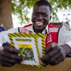 A South Sudan Red Cross volunteer shows seeds given out to women farmers in rural South Sudan to improve agriculture and food production in the onset of the rainy season.