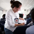 An ICRC staff member assists a released detainee during a humanitarian flight in South Sudan.