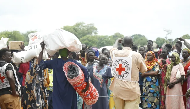 ICRC staff supplying essential items to refugees.