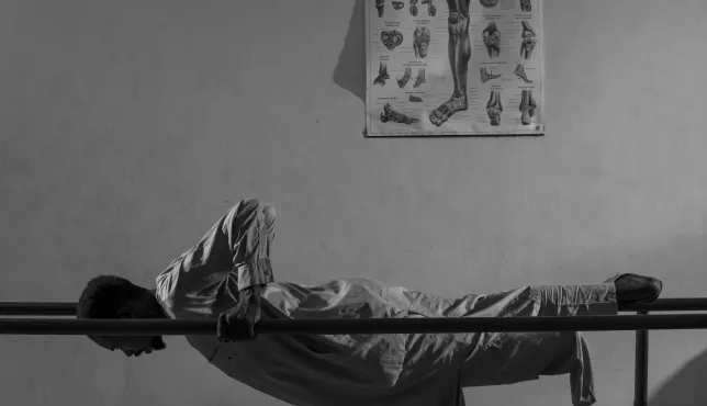 Issa Idriss Hassan, 43, trains on parallel bars at the ICRC-supported Physical Rehabilitation Center at Wau Teaching Hospital.