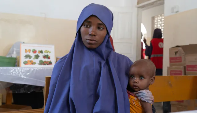 Nurta Ibrahim, 25, with her daughter, Salaada Mohamed at the Somali Red Crescent-run Howlwadaag outpatient therapeutic centre seeking treatment.