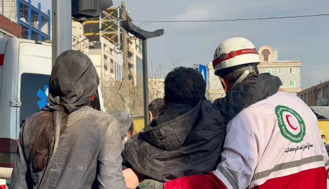 IRCS Rescue and Relief staff help an injured person in Tehran