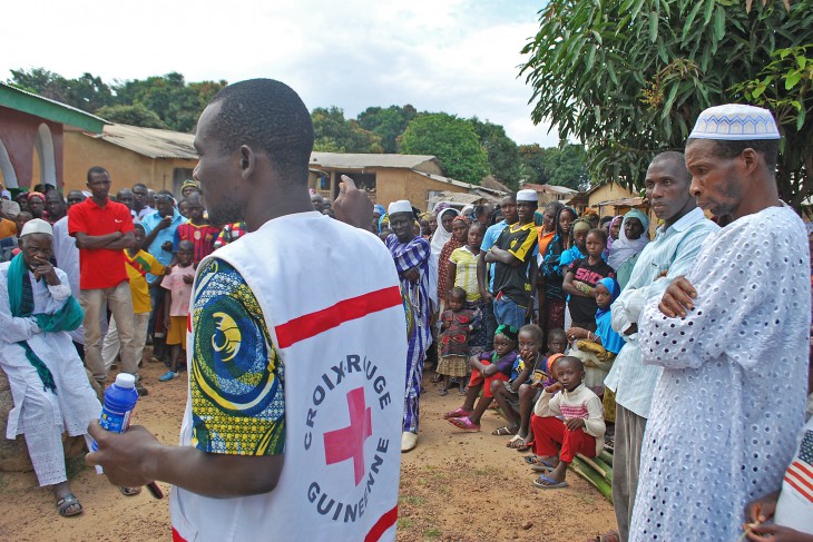 Guinea. A volunteer from the Red Cross Society of Guinea explains Ebola protection measures.