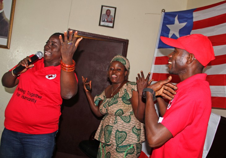 Florence Jlopeh (left) with Ebola survivors Makuka Sirleaf and Gerald Dennis during the live performance of "Let Us Live Together Again"