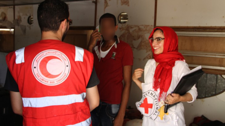 Misrata, Libya. Libyan Red Crescent and ICRC staff work together, enabling a man separated from his family to make contact by phone. © LRCS / A. Alghwail