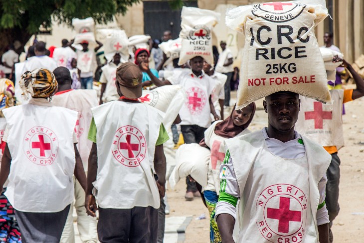 Nigerian Red Cross Society personnel distribute ICRC-supplied food to displaced persons in Maiduguri. The ICRC intends to distribute food to another 500,000 people.