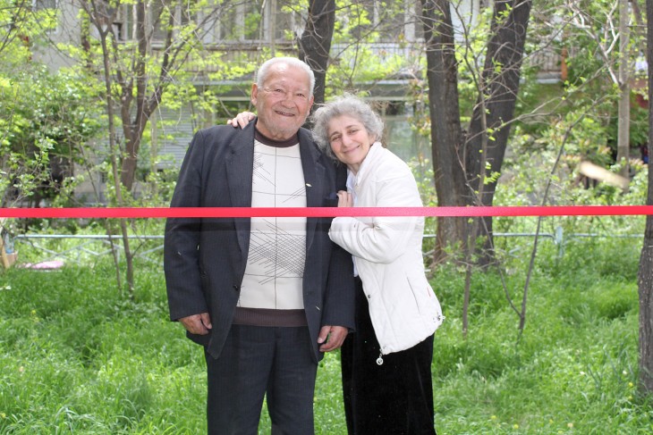 Masis, Armenia. Maria, the daughter of a missing person, gives a warm hug to Vladimir Kaprielov, who is respected and loved by the families of everyone with a missing relative.