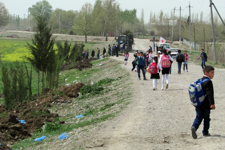 Children have to use this road every day on the way to and from school. But it is exposed to fire from military positions. The trees on the left will screen children and others using the road.