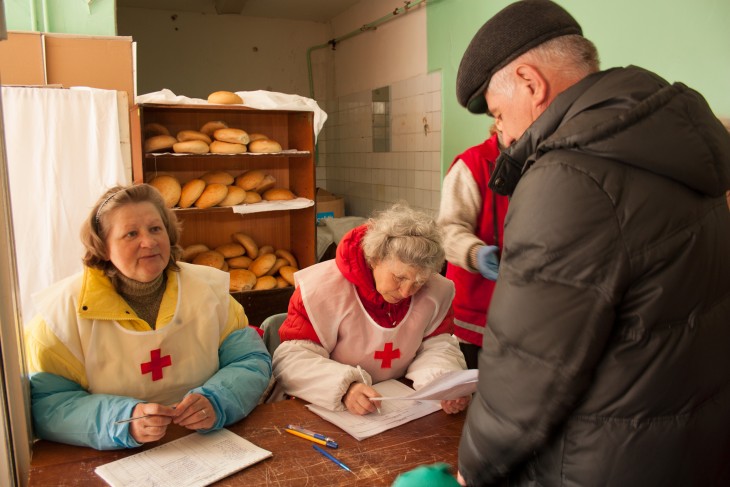 Severodonetsk, Ukraine, 17 April 2015. Lubov Vasilievna (left) helps distribute bread.