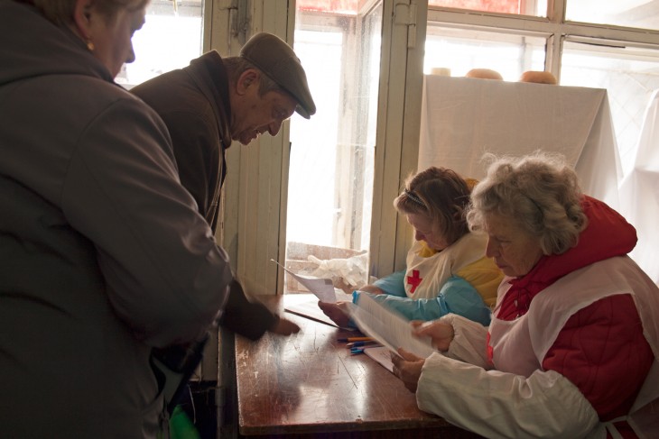 Severodonetsk, Ukraine, 17 April 2015. Lubov and another volunteer check the list of people who are to receive bread.