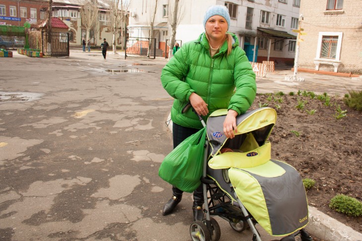 Severodonetsk, Ukraine, 17 April 2015. Inna comes to collect bread every second day, with her five-month-old baby.