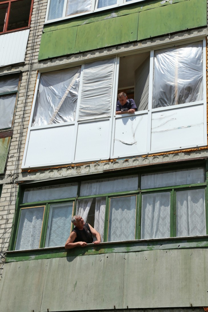 Aleksander Nikolayevich's balcony is still covered in plastic sheeting after a shell smashed into his kitchen. 
