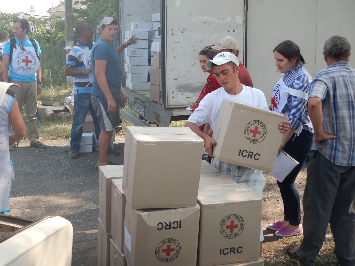 ICRC staff distribute food and other essentials to the people of the village.