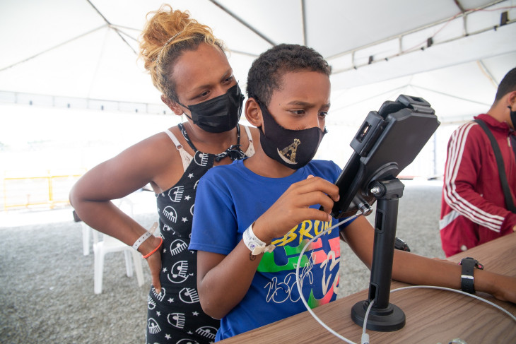 Refugee mother and son access the internet in Brazil